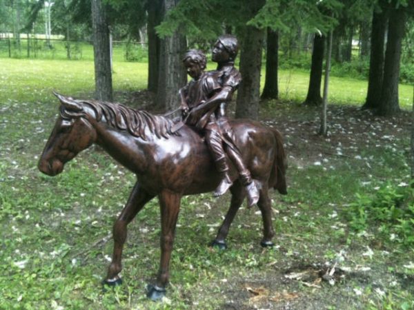 two children on horse aluminum statue side view